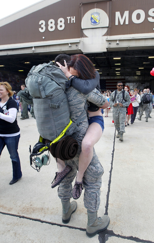 Al Hartmann  |  The Salt Lake Tribune
Paige Higgins gives her husband James a hug as he arrives with the  150 airmen from the 388th Fighter Wing returning to Hill Air Force Base Monday after a six-month deployment to Kunsan Air Base, Republic of Korea. The pilots and maintenance and support crews provided F-16 air support in the region as part of a routine U.S. Pacific Command's Theater Security Package rotation.
